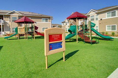a playground with a sign in front of it