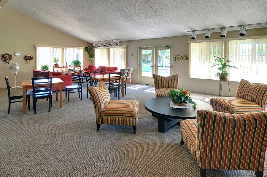 a large living room with a dining room table and chairs