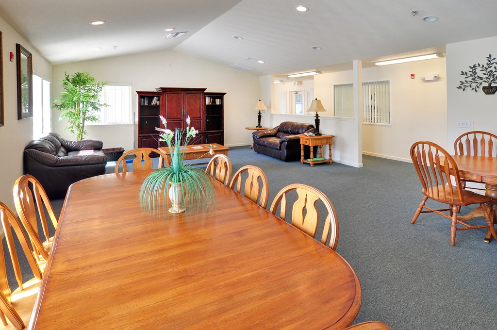 a living room with a wooden table and chairs