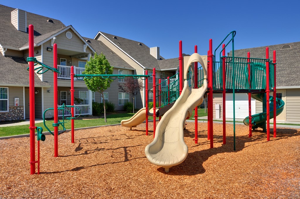 a playground with slides at the villas at falling waters townhomes in west omaha