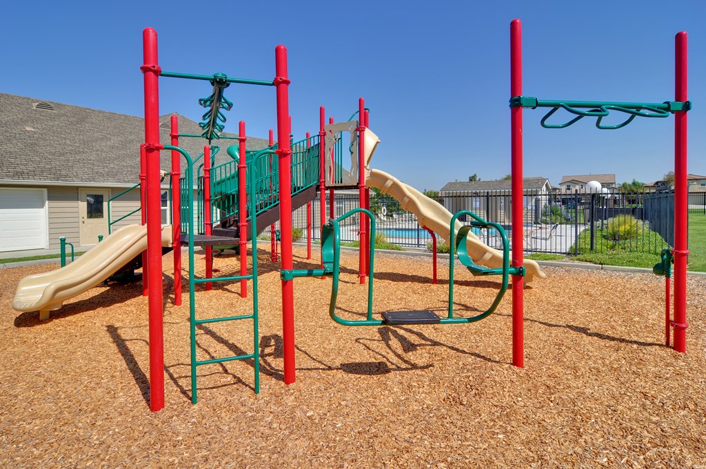 a playground with a slide and monkey bars