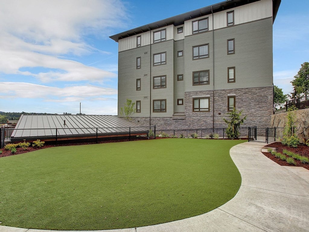 a green lawn in front of a large building