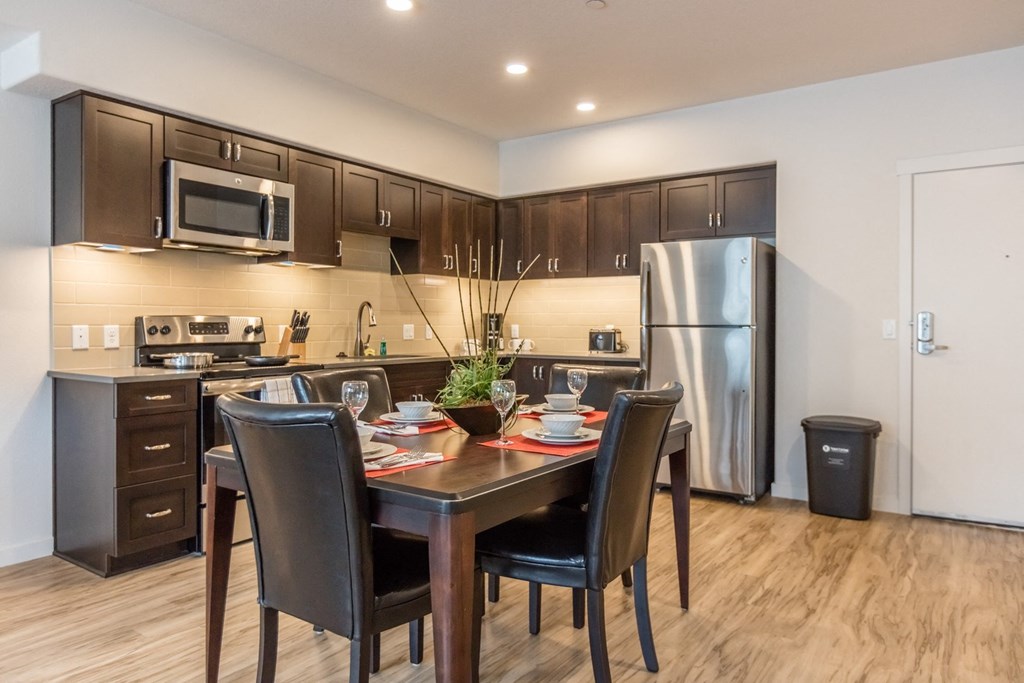 the reserve at city center spacious kitchen and dining area with stainless steel appliances
