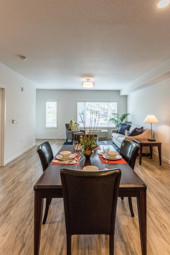 an open living room and dining room with a table and chairs