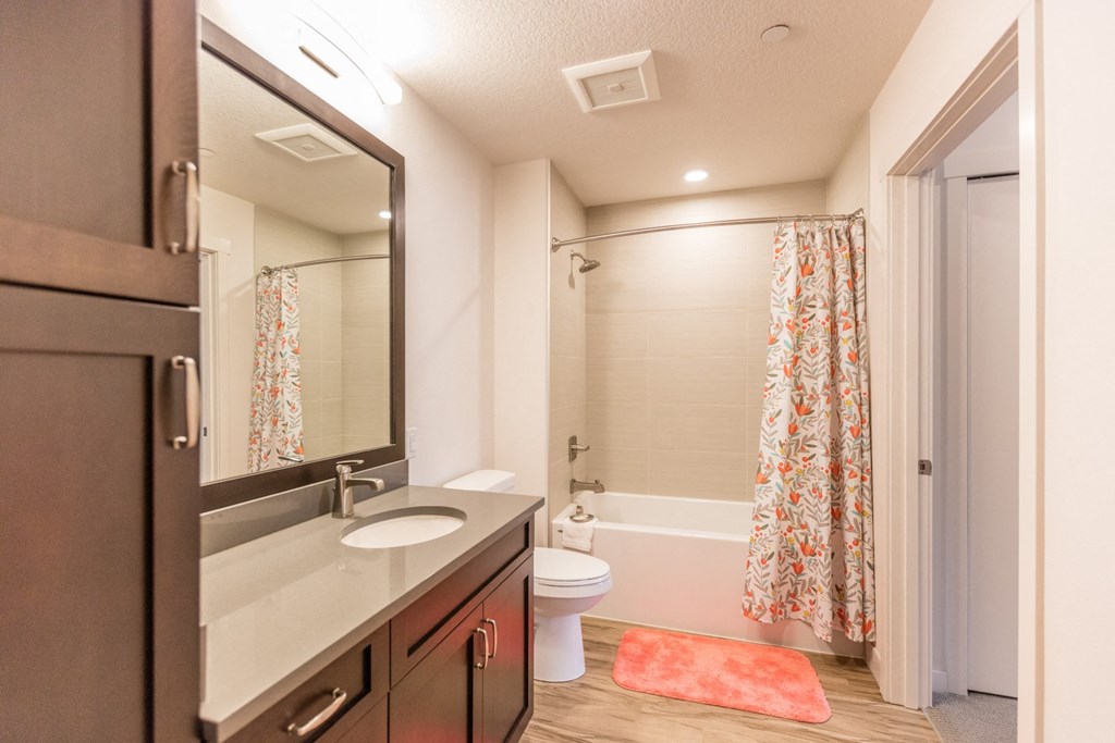 a bathroom with a sink and a shower and a toilet