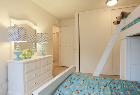 a bedroom with a bed and a mirror and a closet