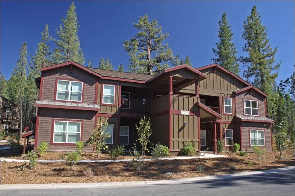 a large red house with trees in the background
