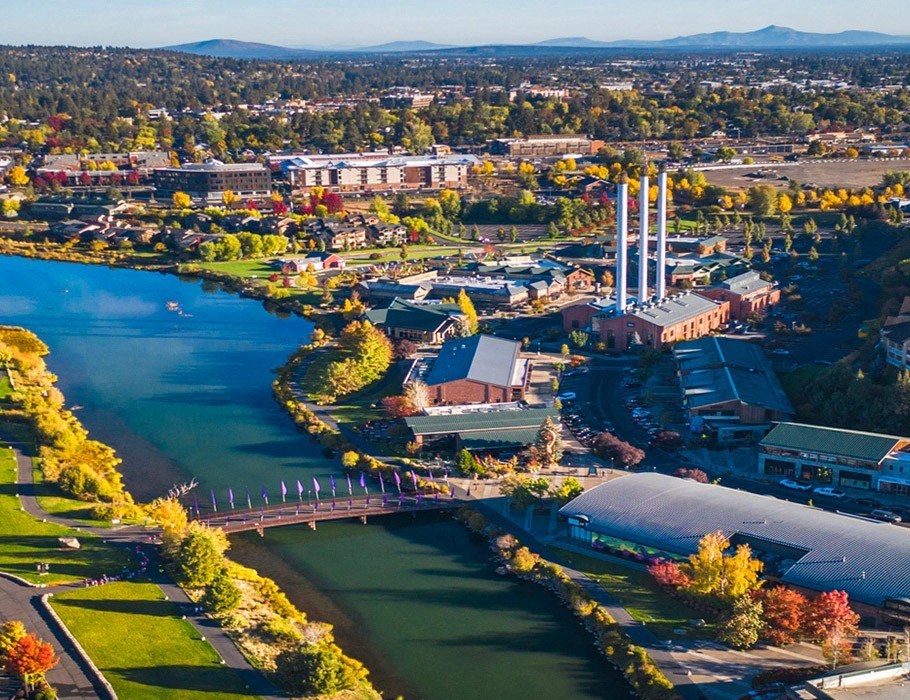 an aerial view of a city with a river and buildings