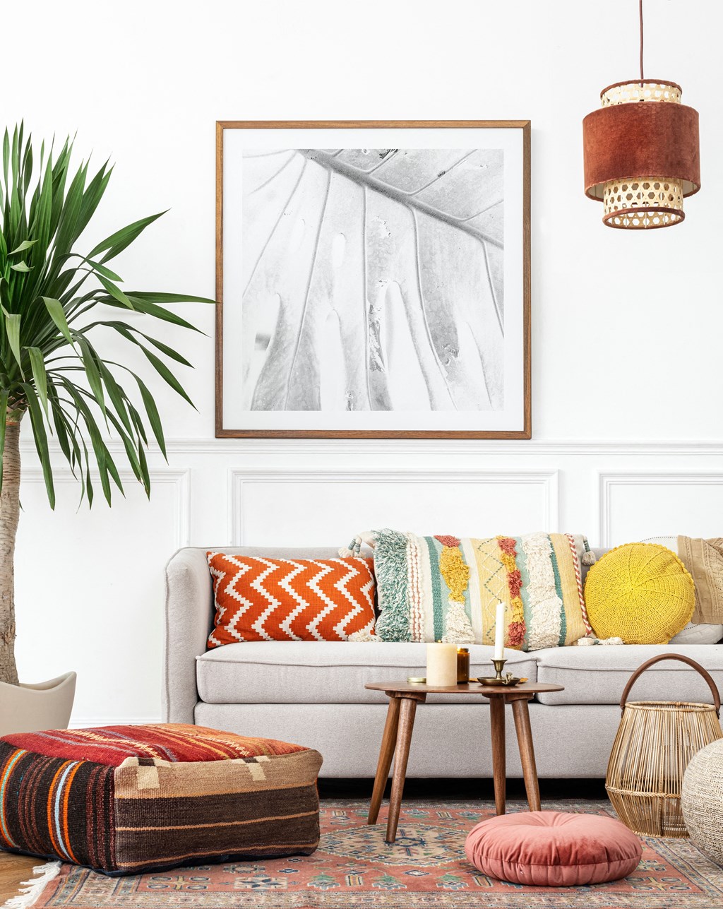a living room with a couch and pillows and a picture on the wall