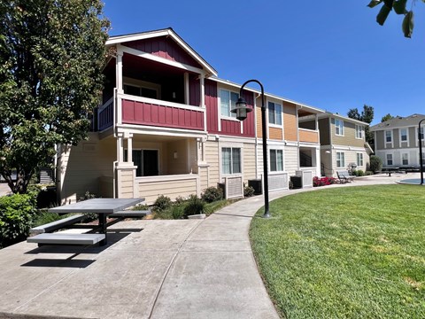 A red and white building with a picnic table in front of it.