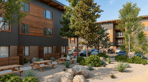 A modern building with wooden accents and a landscaped courtyard.