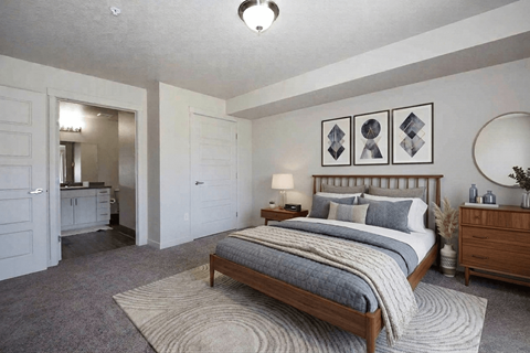 A bedroom with a large bed and a mirror on the wall.