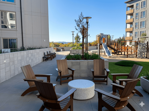 A patio with chairs and a table.