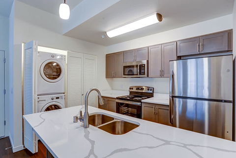 a kitchen with stainless steel appliances and a white counter top