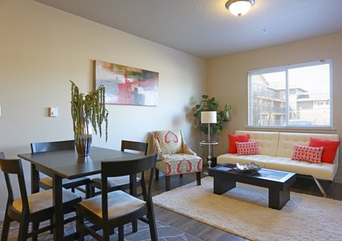 a living room and dining room with a table and couch