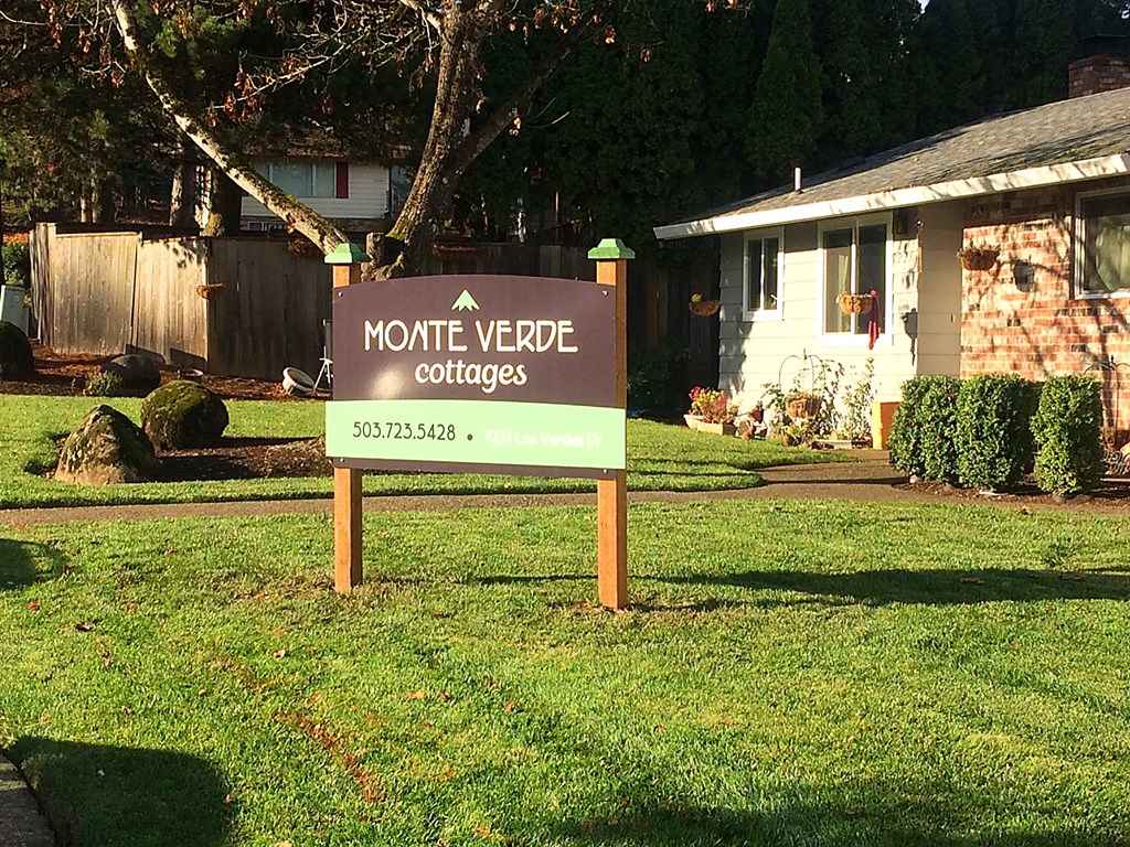a sign for a monte verde coffee shop in front of a house