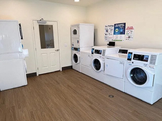 A laundry room with a washer and dryer stacked on top of each other.