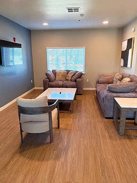 A living room with a couch, chair, and coffee table.