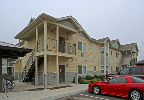a car parked in front of an apartment building