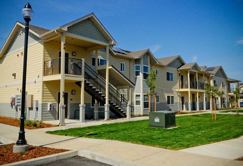 a row of yellow apartments with stairs