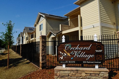 a sign in front of a row of houses
