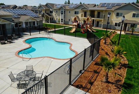 a swimming pool in front of an apartment complex