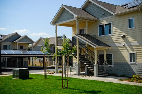 a row of houses with solar panels in the yard