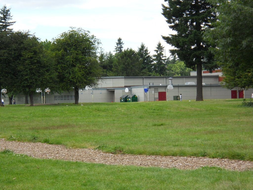 a building with trees and grass in front of it