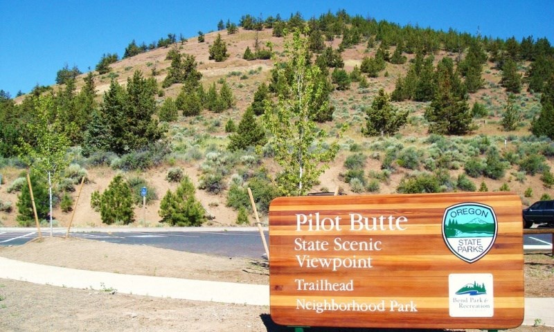 a sign for the pilot butte state scenic viewpoint on the side of a mountain
