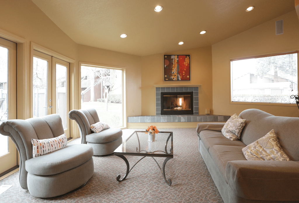 a living room with a fireplace and a couch and chairs