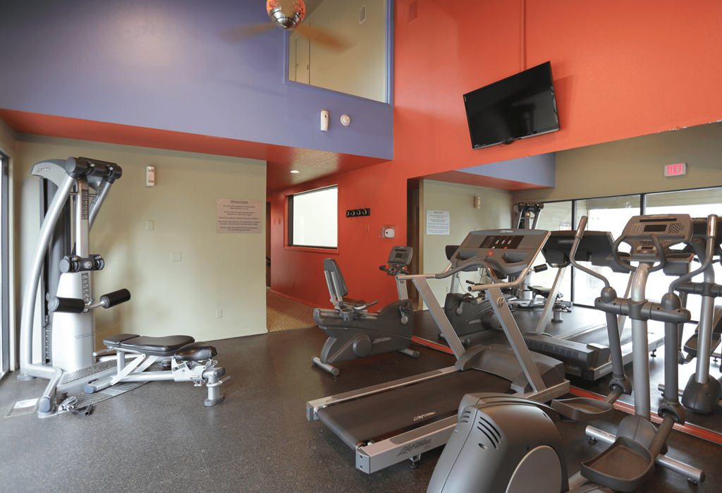 a room with a lot of exercise equipment in it