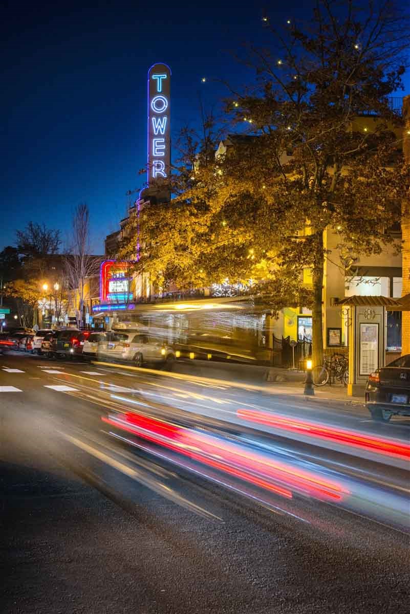 a city street at night with a blur of traffic