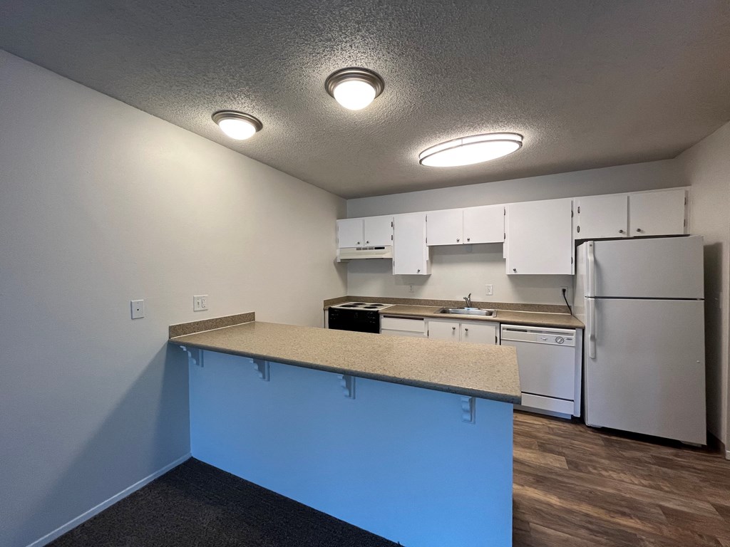 a kitchen with white cabinets and white appliances