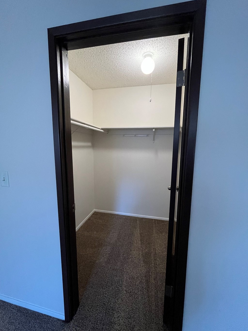 a bedroom with a closet and a light in the ceiling
