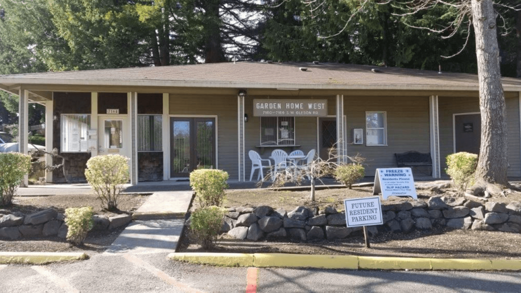 a building with a sign in front of it that reads garden park rest