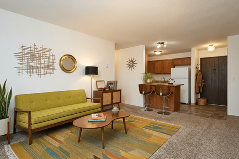 A living room with a green couch and a coffee table.