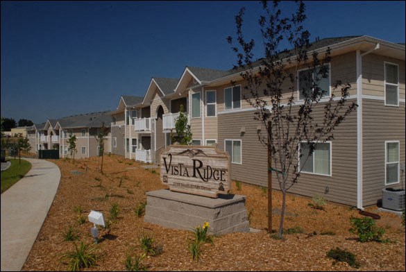 a view of the villas at vision river in front of a sign in front