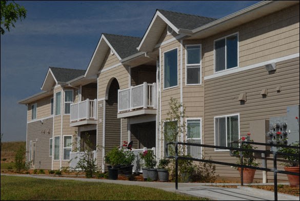 a row of houses with balconies and a sidewalk