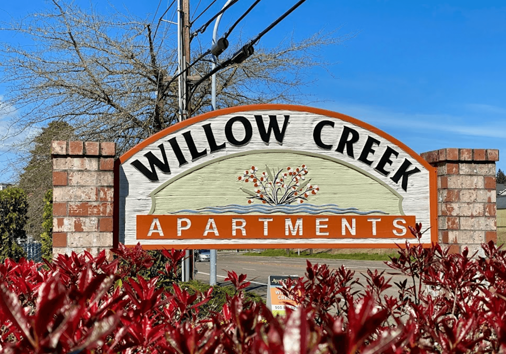a sign that reads willow creek apartments