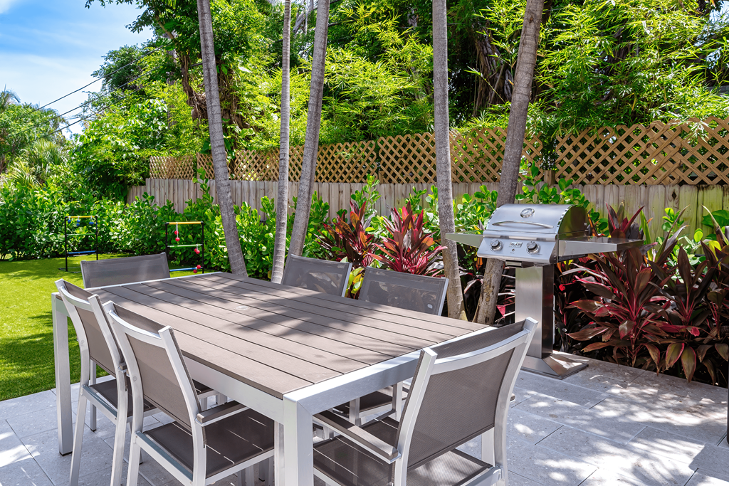 A table and chairs set up outside in a garden.