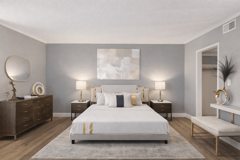 A bedroom with a large bed, nightstands, and a bench.