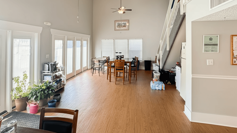 A living room with a dining table and chairs.