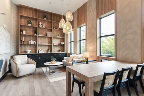 A modern dining room with a wooden table and chairs.