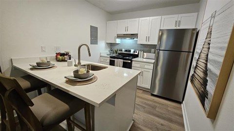 A modern kitchen with a dining table and chairs.