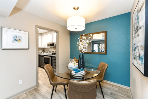 A dining room with a table set for four.