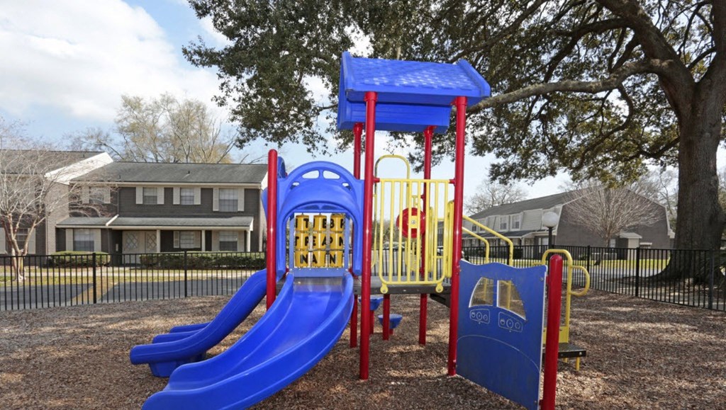 a playground with slides and swings at a park