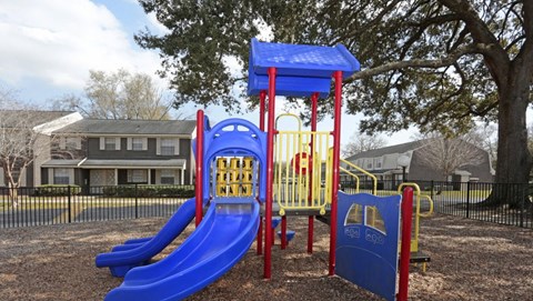 a playground with slides and swings at a park