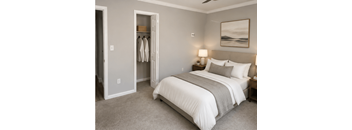 A bedroom with a large bed and a painting on the wall.