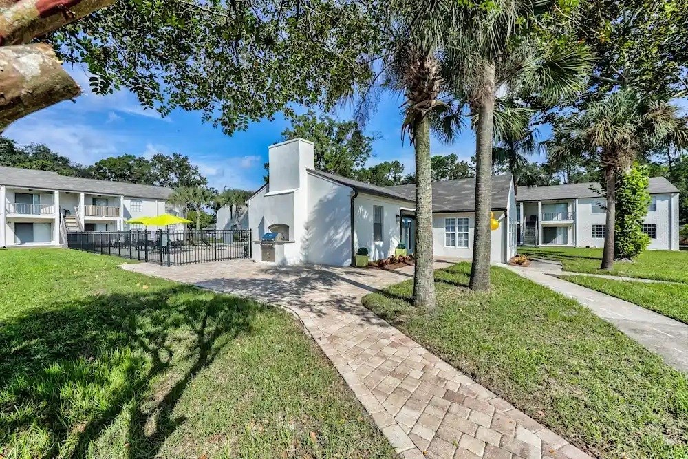 A sunny day at a residential area with a house in the center.
