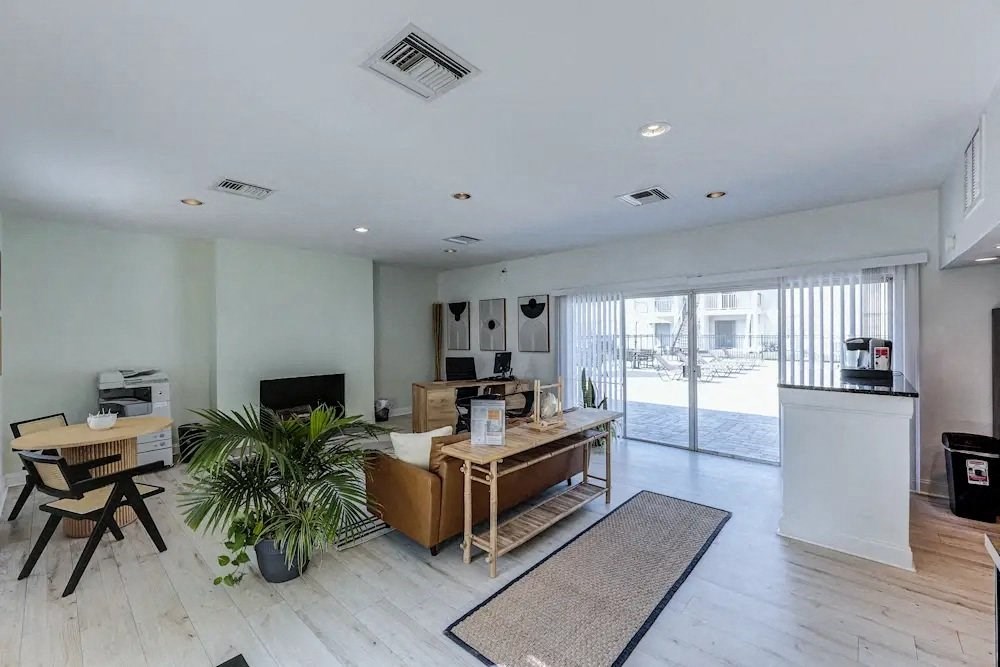 A living room with a white ceiling and a large window.
